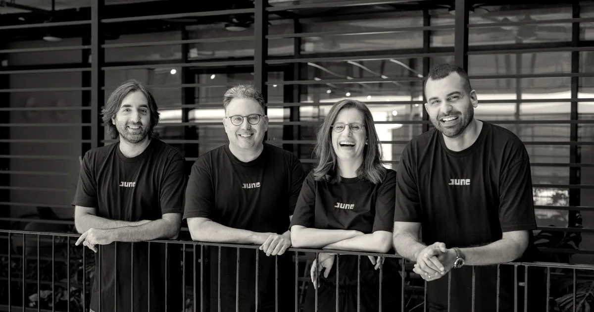 Four members of the June founding team standing together and leaning against a railing.