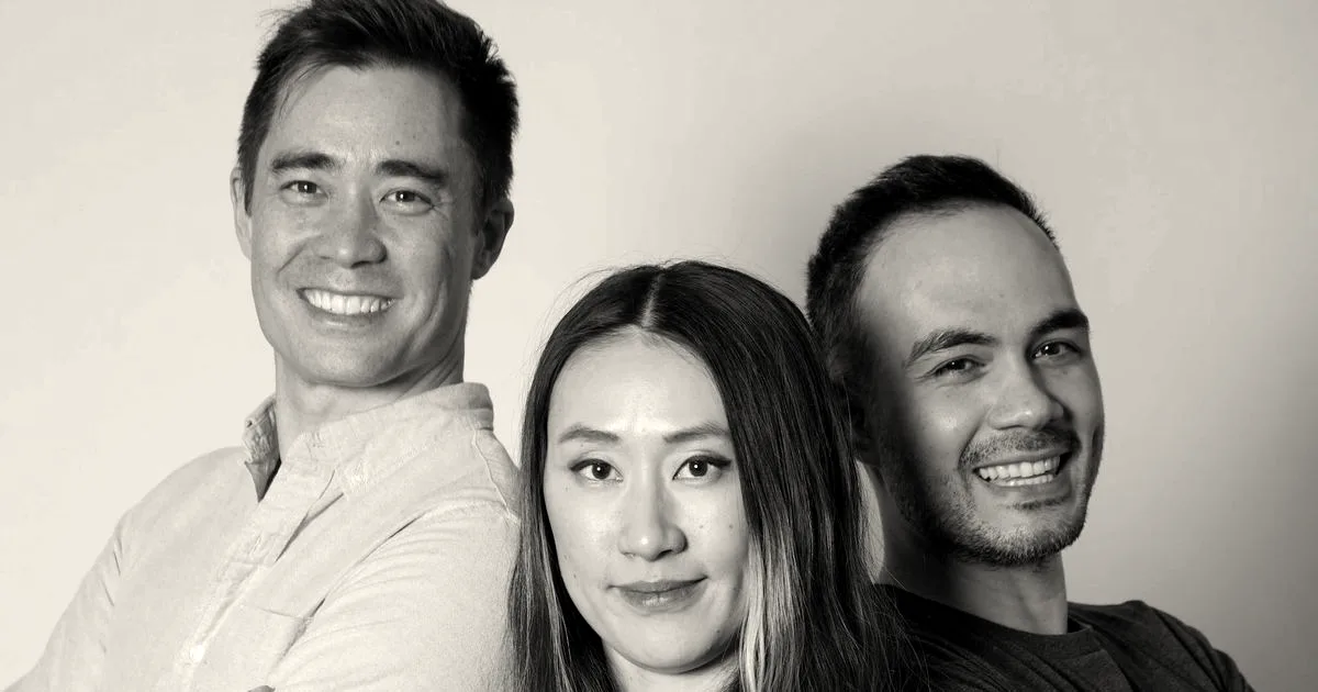 Three co-founders of TypeSafe AI standing together against a light background with arms crossed, smiling.