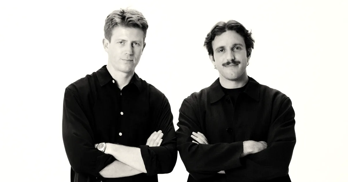 Two male founders of Profound standing side by side with arms crossed against a white background