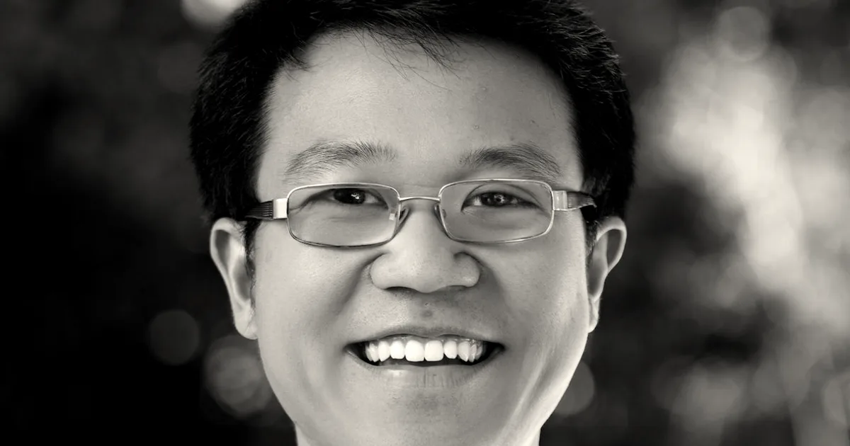 Portrait photograph of Cognition founder and CEO Scott Wu smiling against a soft blurred background.