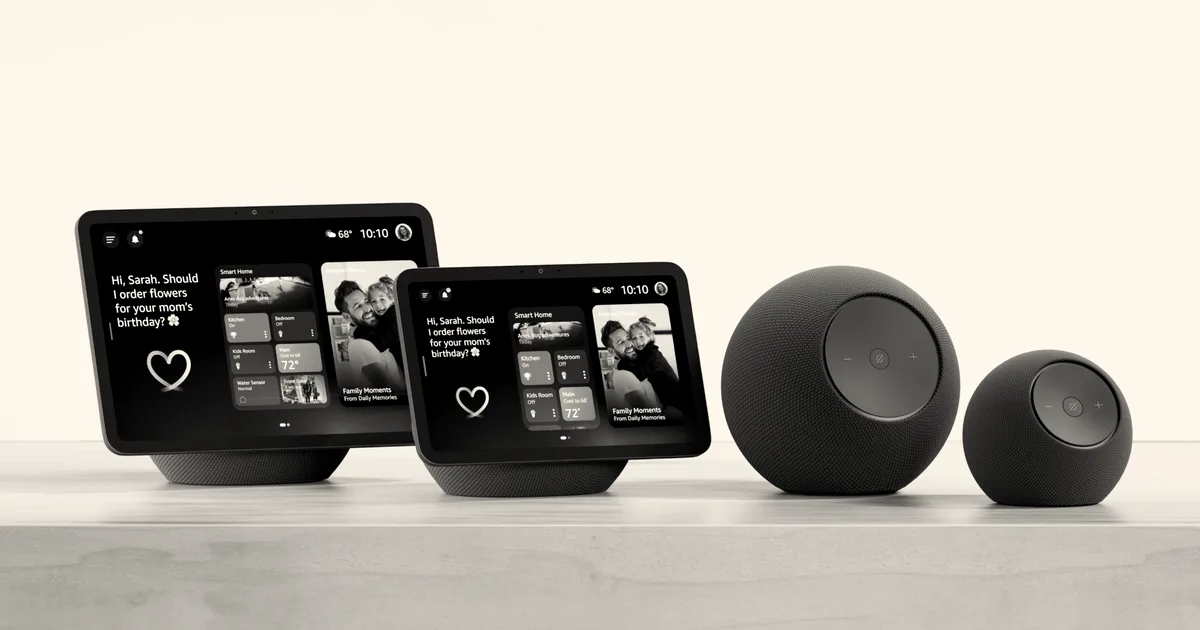 A line of Amazon smart devices including Echo Show smart displays and Echo smart speakers on a wooden table.