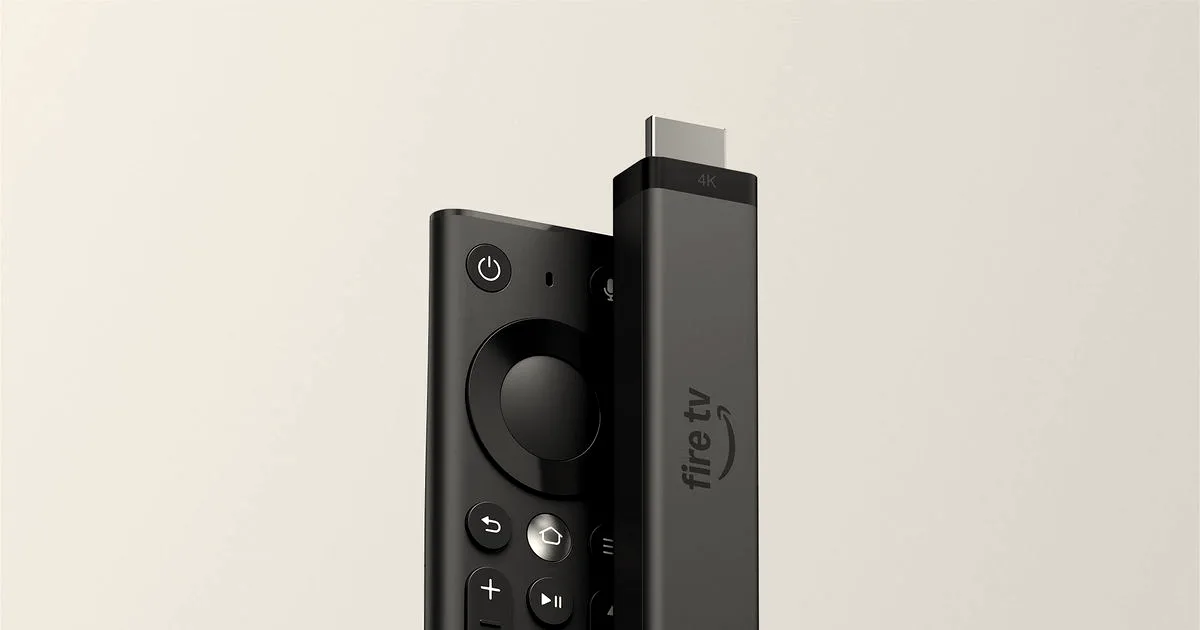 Amazon Fire TV Stick 4K streaming device positioned upright next to its black remote control.