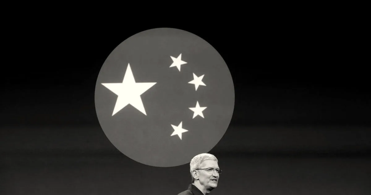 Apple CEO Tim Cook speaking on stage in front of a large presentation screen displaying a China flag motif.