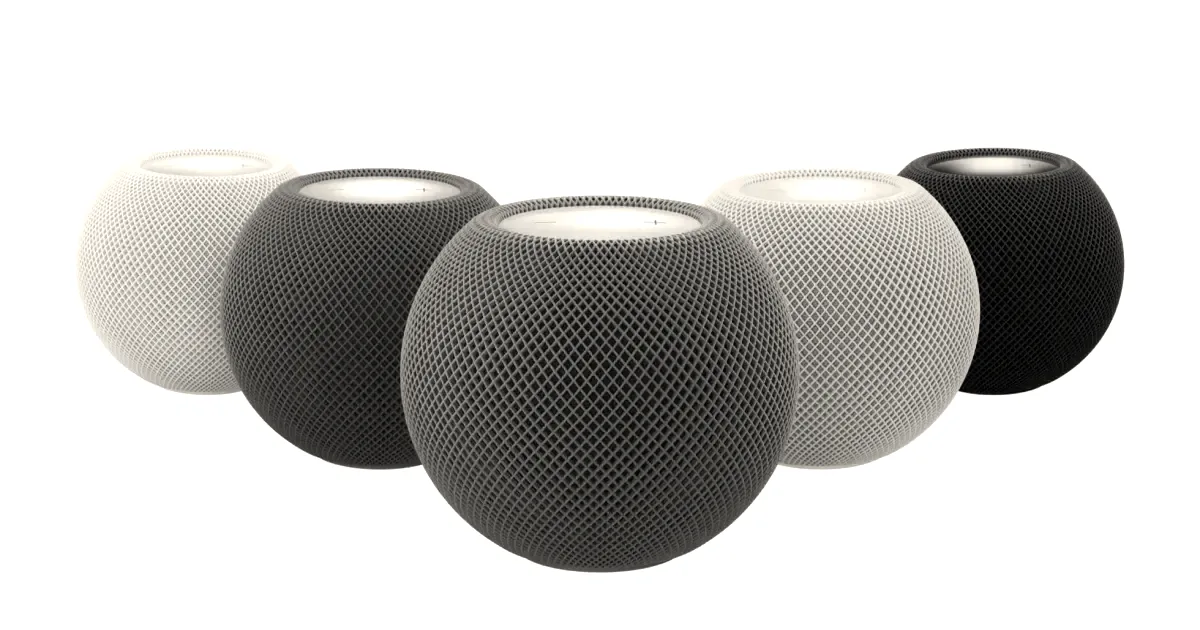 Five colorful Apple HomePod mini smart speakers lined up in a row against a white background.
