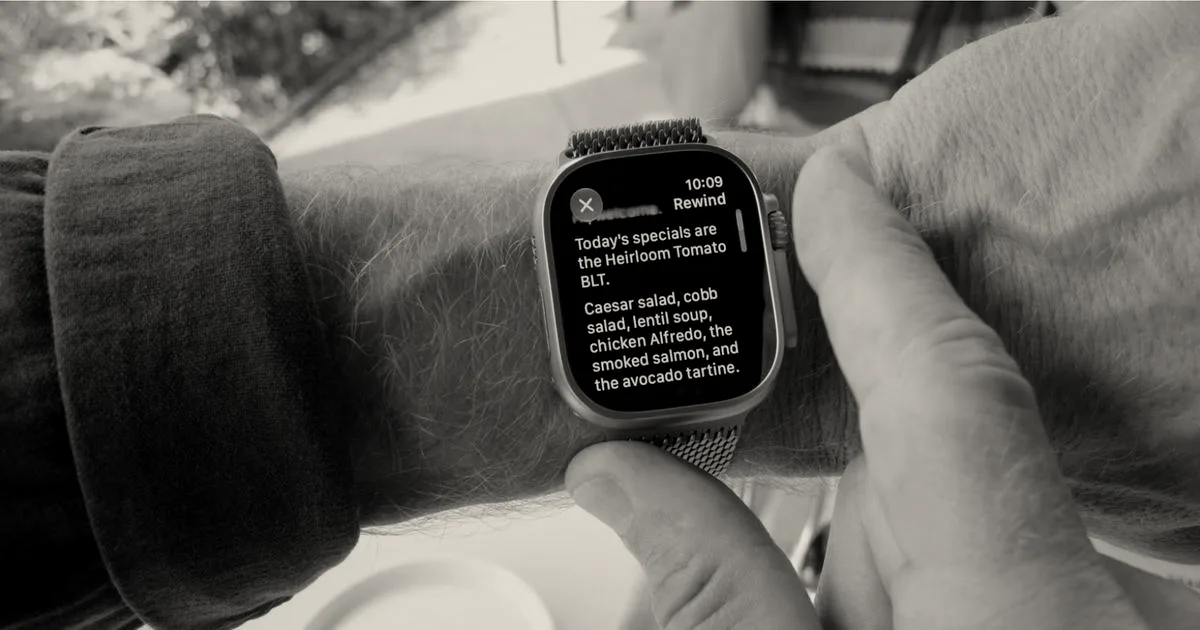 An Apple Watch on a person's wrist displaying a transcribed text recap of daily restaurant specials.