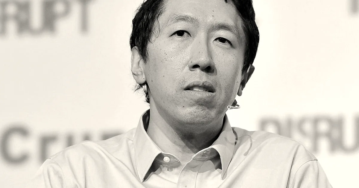 Andrew Ng speaking at a TechCrunch Disrupt conference with hands gesturing while seated on stage.