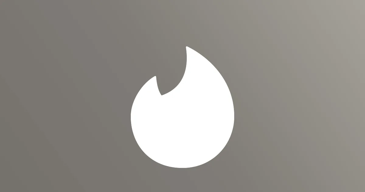Tinder flame logo in white centered against a warm pink to orange gradient background