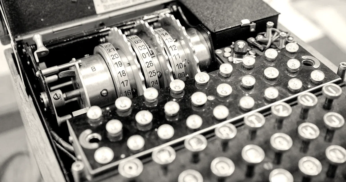 Close-up of a historical Enigma cipher machine showing mechanical rotors and typewriter-style keys