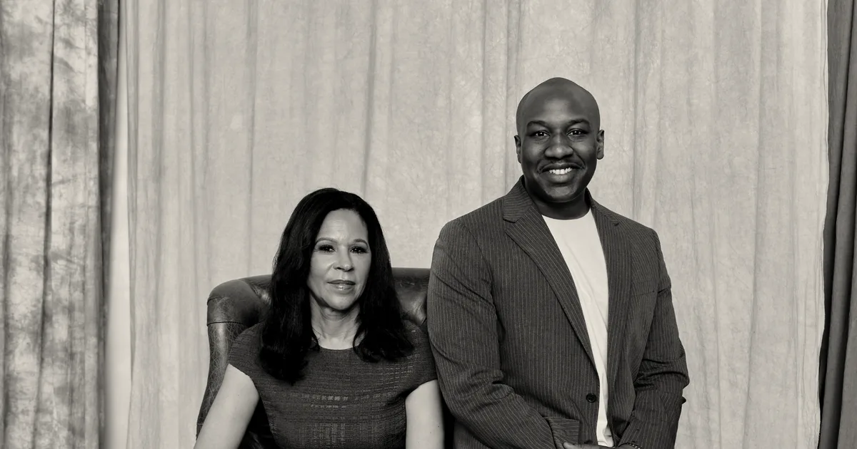 Portrait of the two founders of BAG Ventures seated next to each other in front of curtains.