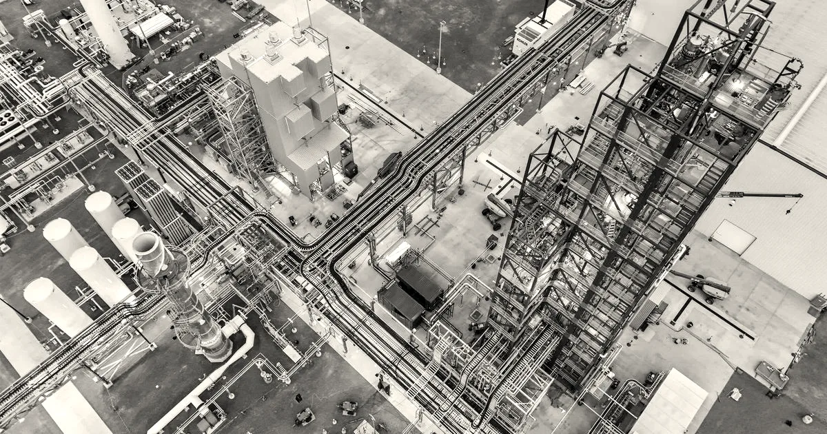 Aerial oblique close-up view of pipes, structures, and equipment at Sila's Moses Lake battery materials factory.