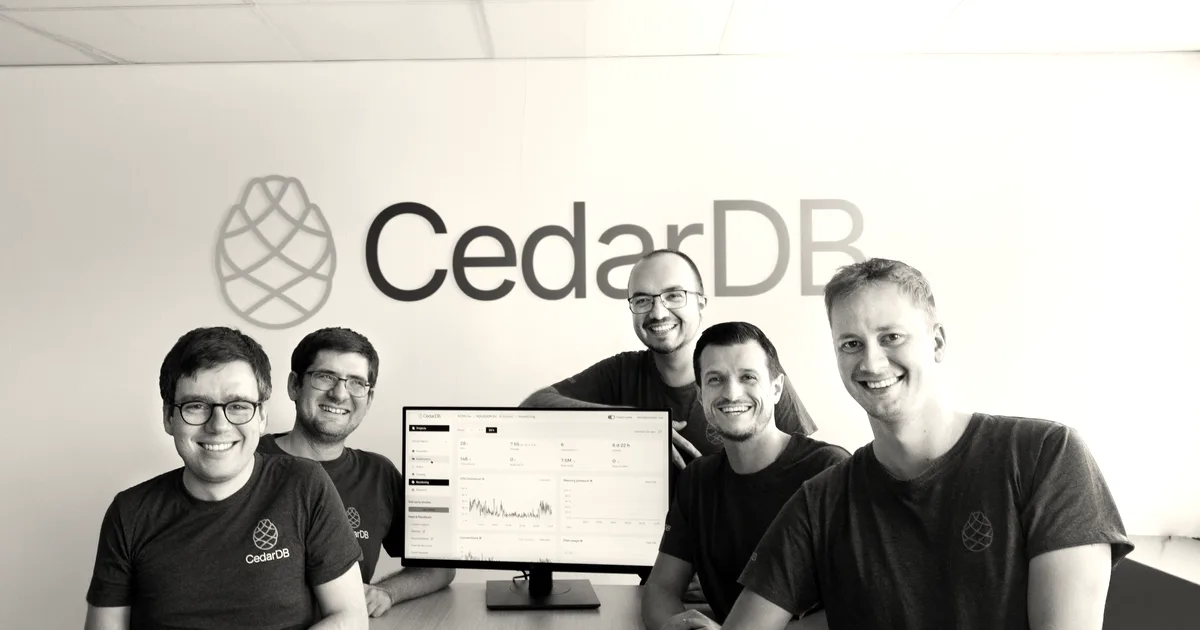 The five founders of CedarDB smiling together around a conference table in front of their company logo