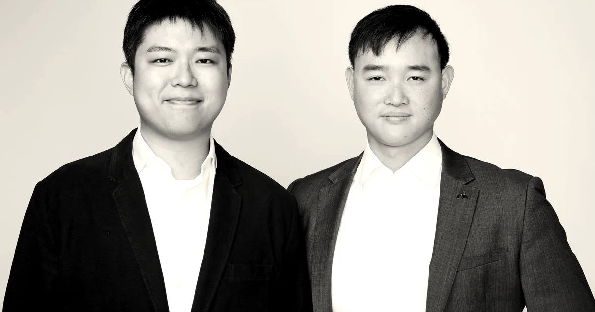 Black and white portrait of Charter Space co-founders Yukun Yin and Yuk Chi Chan posing together.