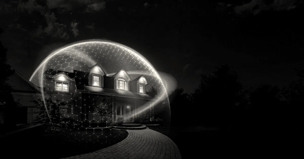 An illustration of a suburban house illuminated at night under a glowing purple protective shield grid.