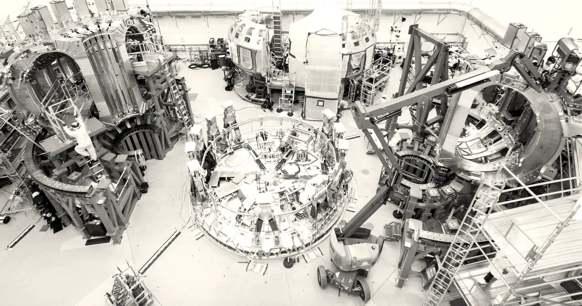 Engineers and machinery assembling components in an advanced industrial fusion reactor research facility.