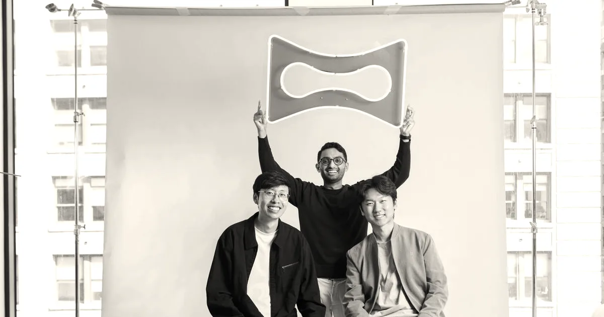 Three co-founders of Melius posing in a studio while holding up their orange brand logo frame.