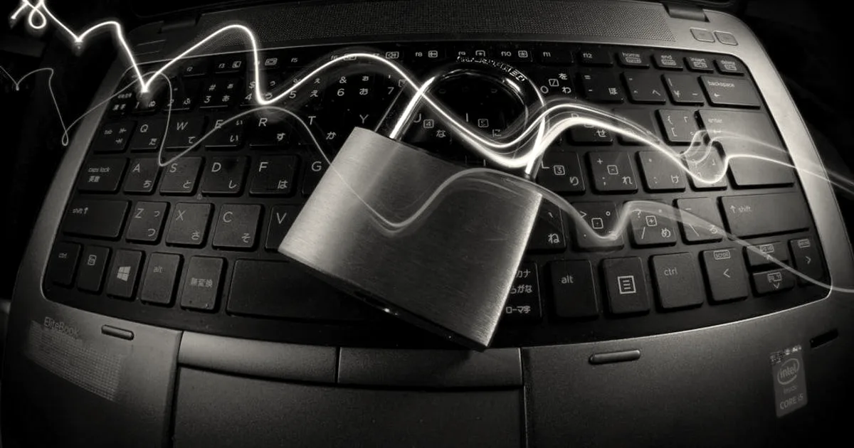 A close-up of a laptop keyboard with a padlock and glowing light streaks representing cybersecurity.