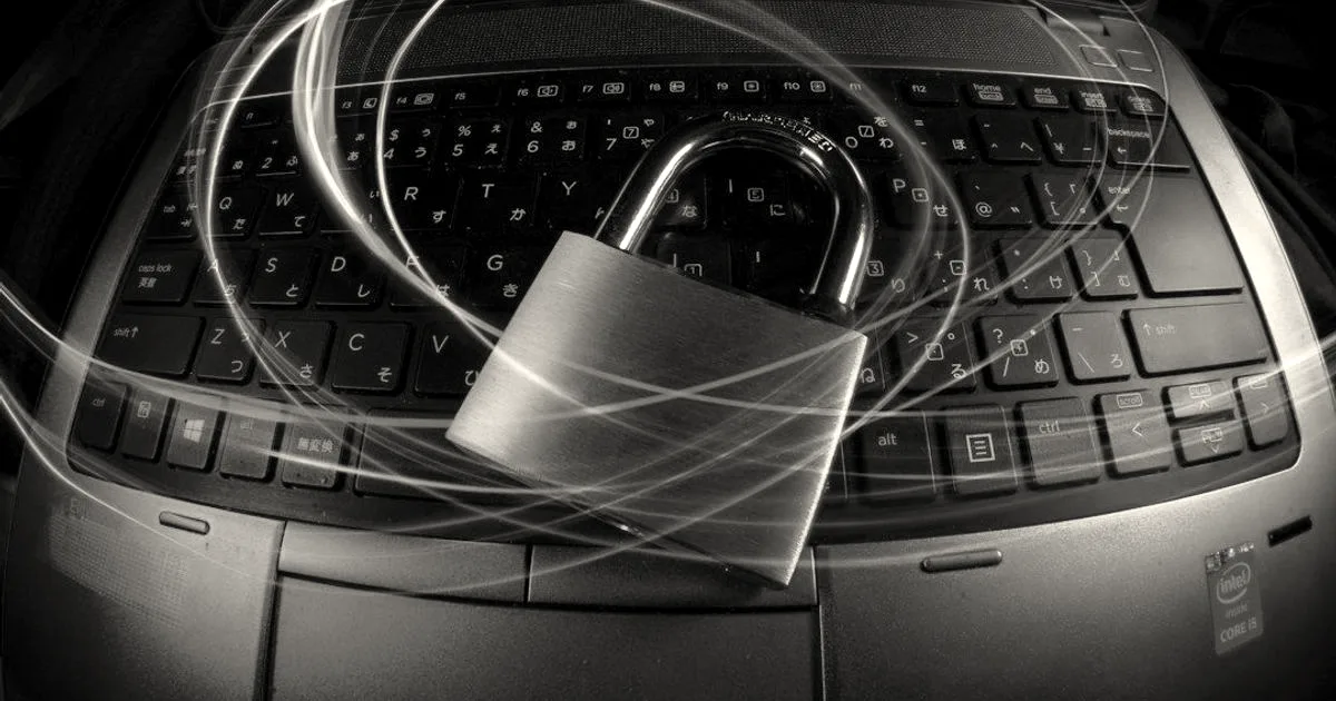 A brass padlock resting on a laptop keyboard surrounded by glowing streaks of colorful light.