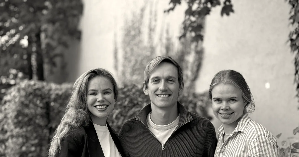 Three co-founders of Furo, two women and one man, standing outdoors and smiling at the camera.