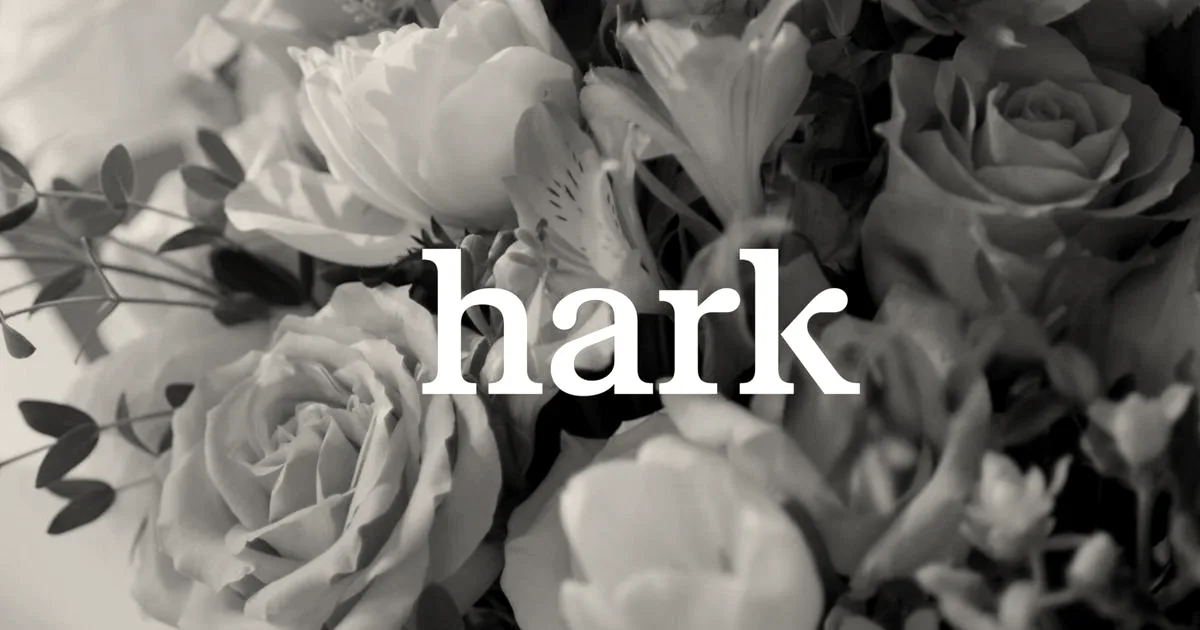 The word hark written in lowercase white text against a soft background of mixed pastel flowers.