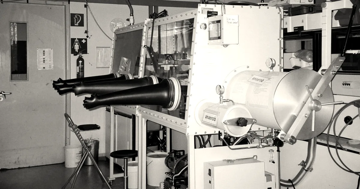 An industrial laboratory setup featuring a glove box for handling sensitive materials safely.
