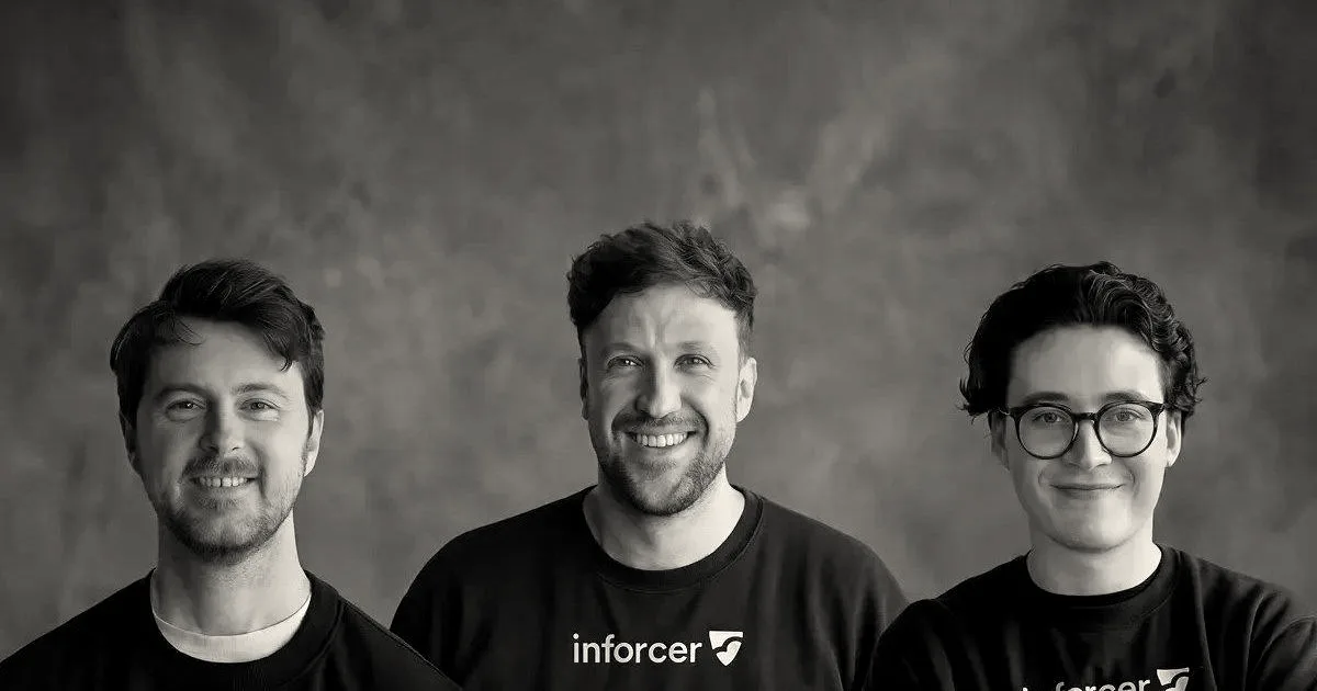 Three founders of Inforcer wearing black sweatshirts with the company logo against a neutral backdrop.