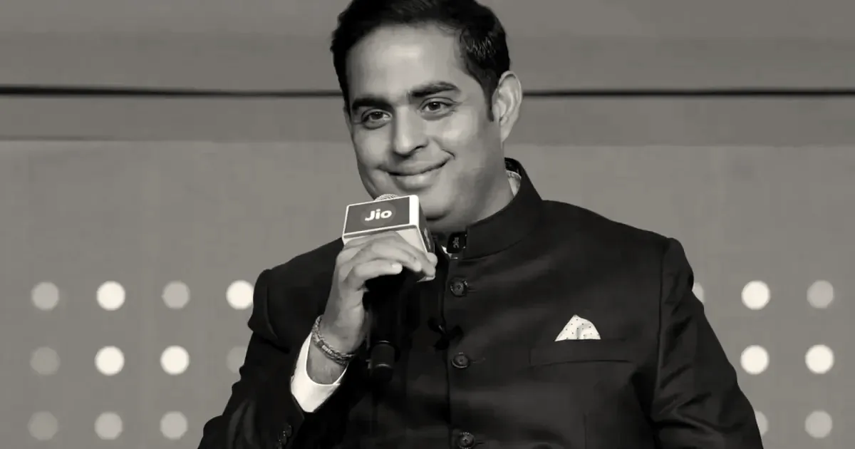 Akash Ambani, managing director of Jio Platforms, speaking into a microphone with a Jio logo.