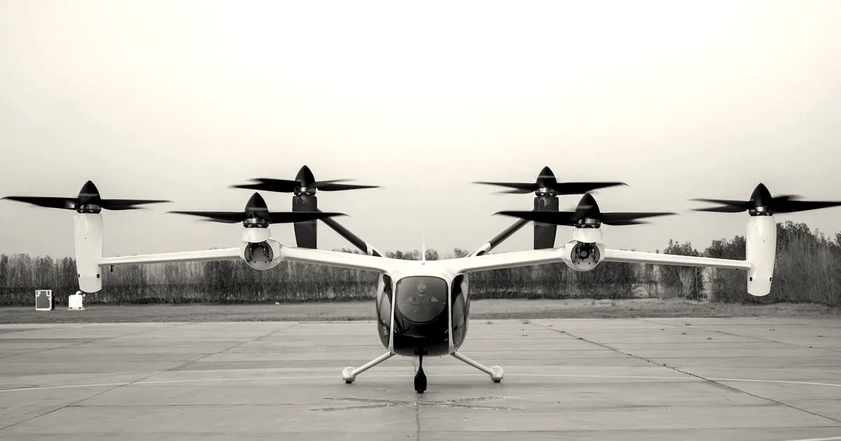 A white Joby Aviation electric vertical takeoff and landing aircraft positioned on a concrete runway.