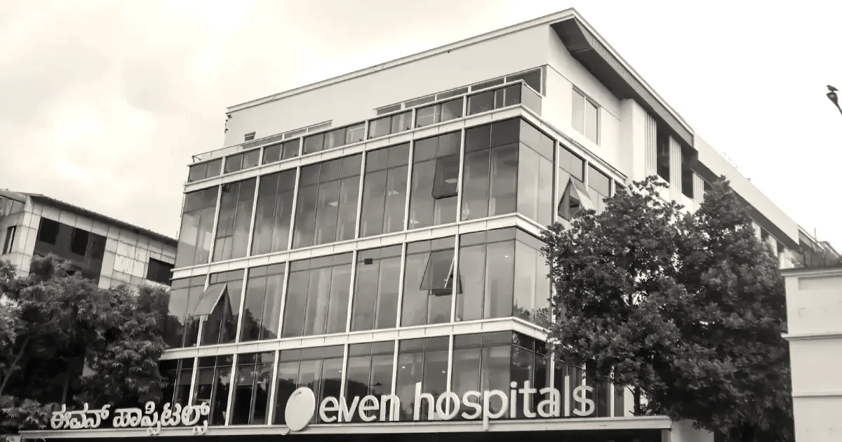 Exterior view of an Even Hospitals multi-story building featuring modern glass facade and signage.