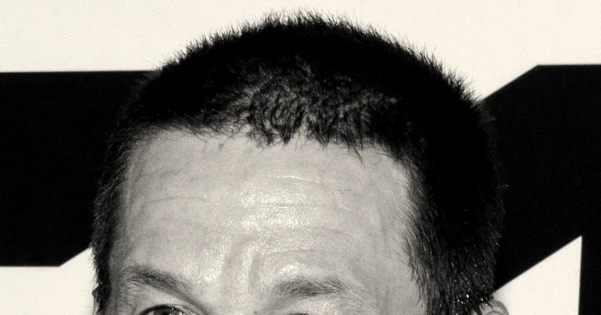 Close-up portrait of actor and entrepreneur Mark Wahlberg smiling at an event.
