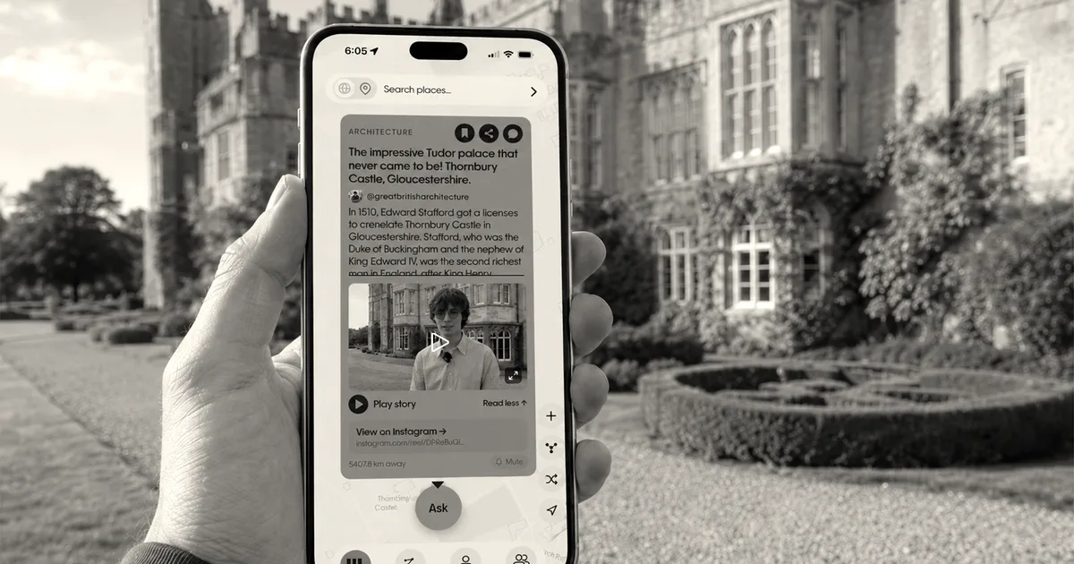 A hand holding a smartphone showing the Wrinkles app in front of a historic manor house.