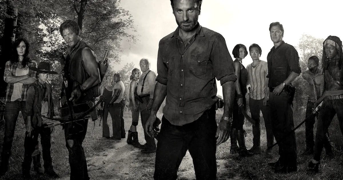 An ensemble cast promotional photo featuring characters from the television series The Walking Dead standing outdoors.