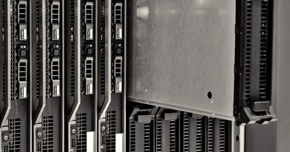 Close-up of server blade modules illuminated by cool blue lights inside a modern data center rack.