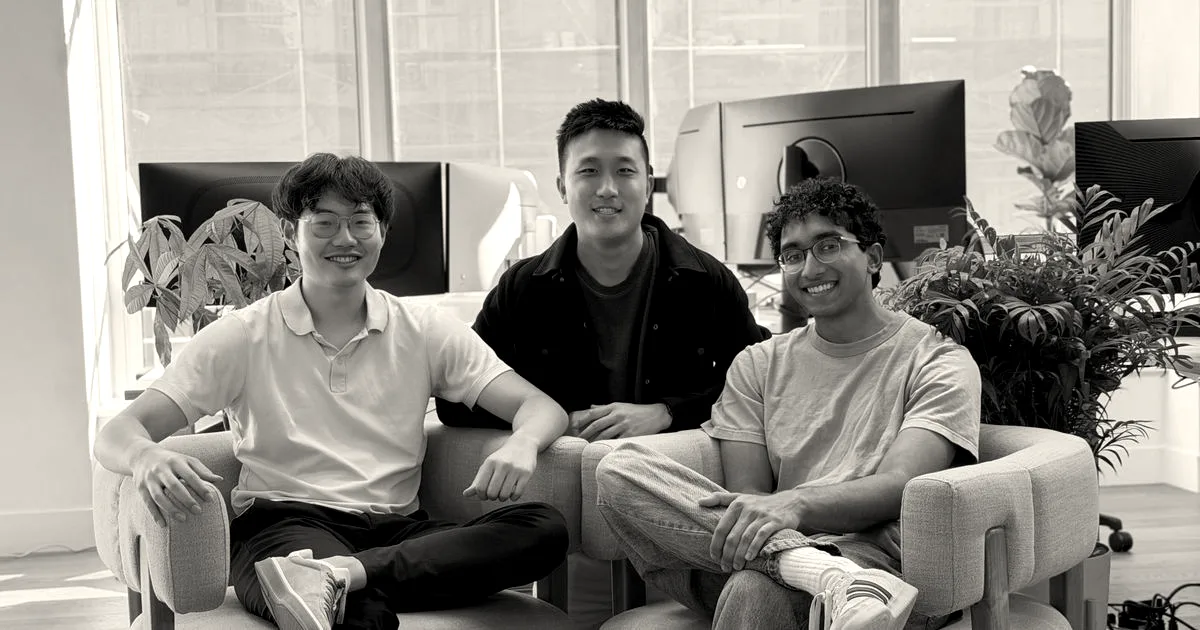 Three male founders of Polar sitting in office chairs and smiling at the camera.
