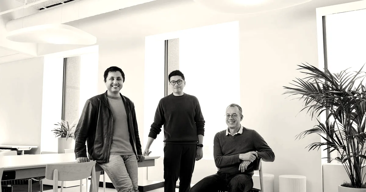 Three founders of Arena posing in a brightly lit modern office space.