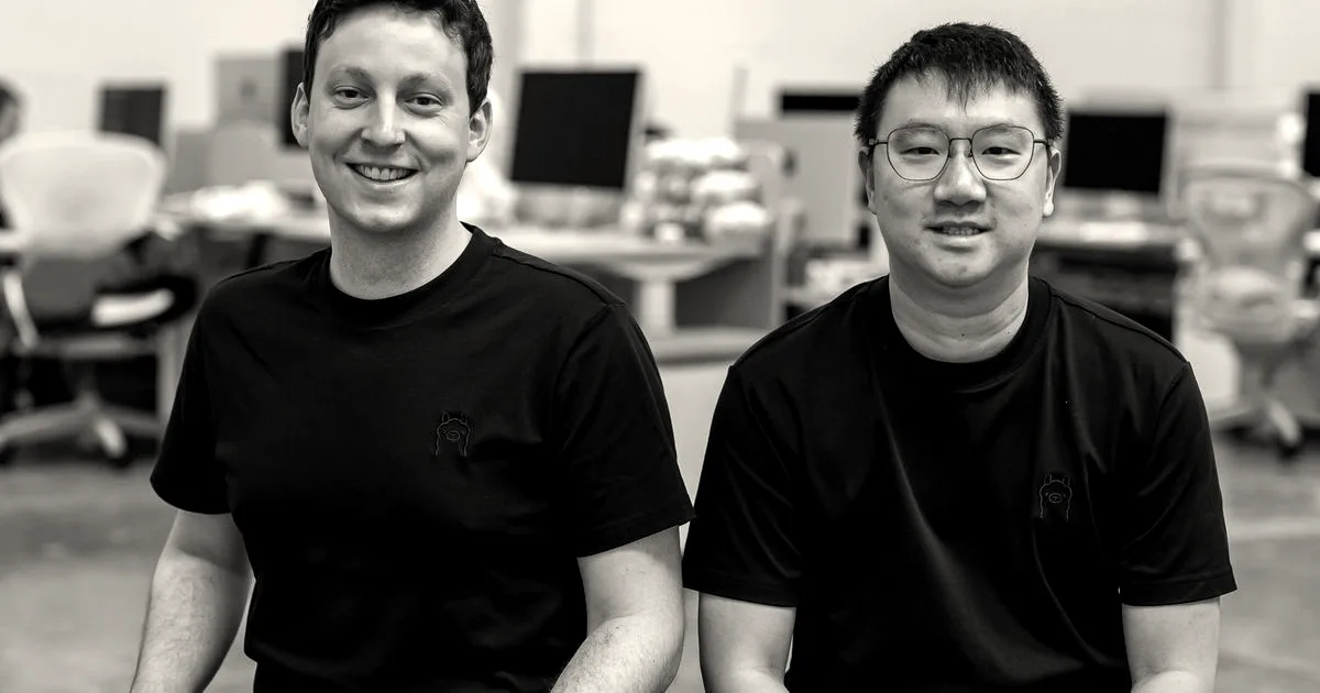 Ollama co-founders Jeff Morgan and Michael Chiang smiling, seated in an office workspace