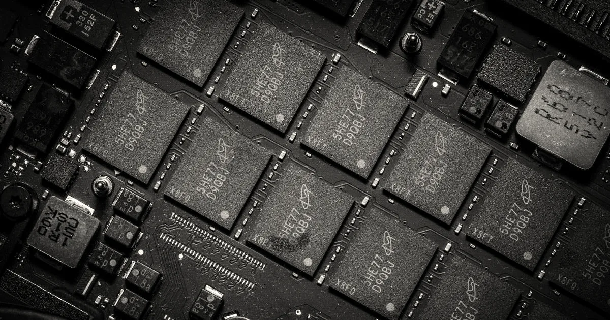 Close-up angled view of modern computer memory microchips mounted on a dark circuit board
