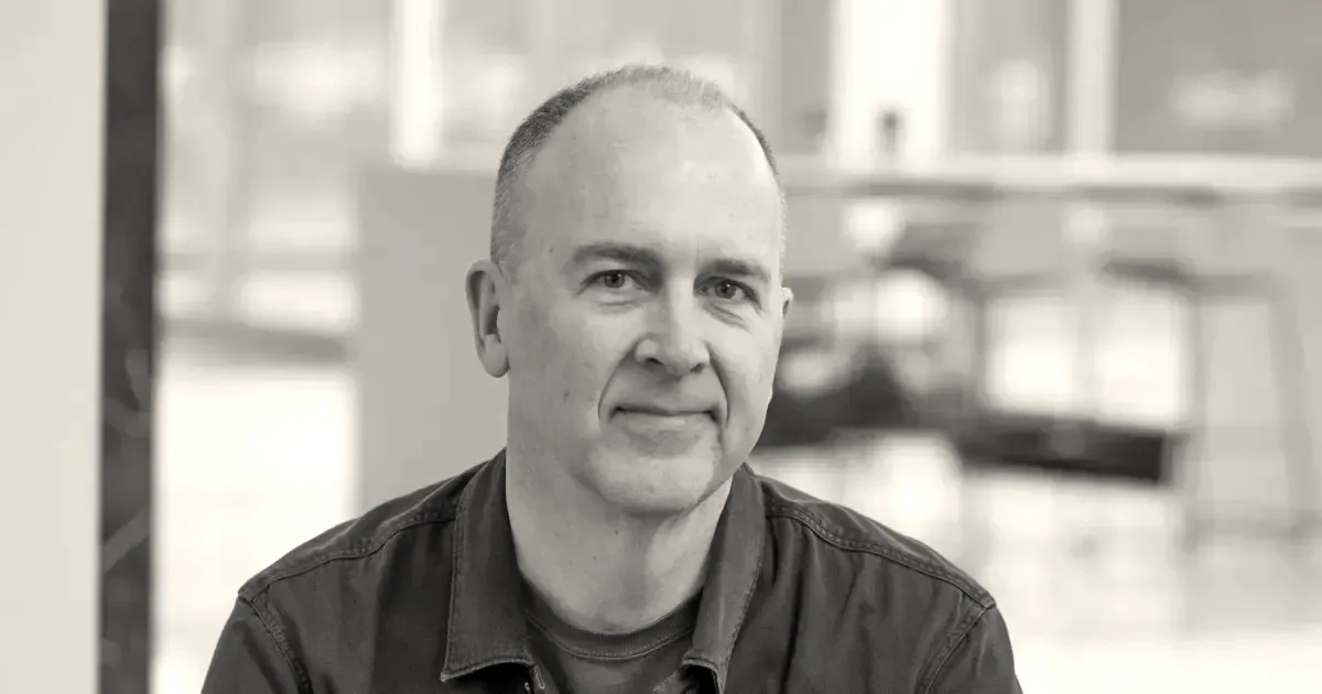 Close-up portrait of Doug Field smiling indoors in front of a soft background