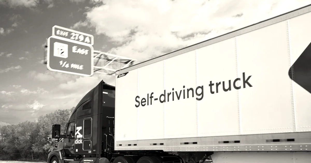 A red Kodiak self-driving semi-truck hauling a white trailer labeled Self-driving truck on a highway