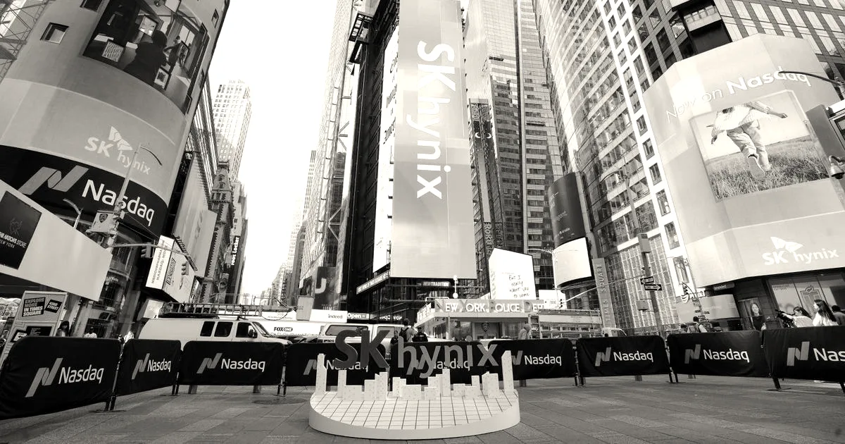 A wide shot of Times Square in New York City featuring large digital billboards displaying the SK Hynix logo.