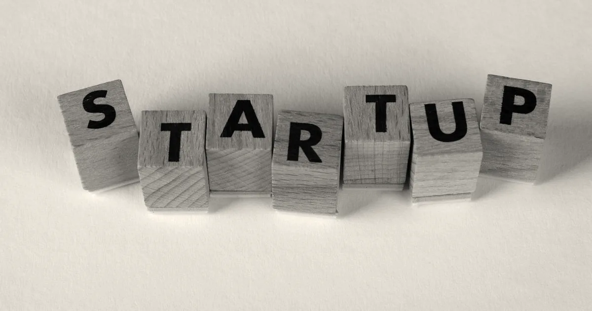 Wooden blocks spelling the word STARTUP on a neutral background, representing a new business venture.