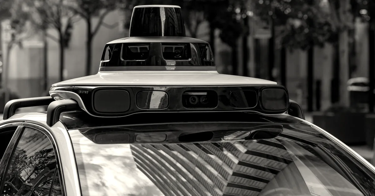 Detailed view of sensors atop an autonomous car, showcasing advanced technology in an urban setting.