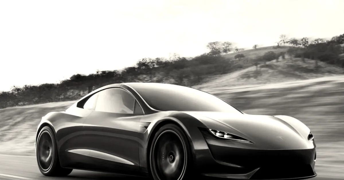 A sleek red Tesla Roadster driving dynamically along an open road against a hilly landscape.