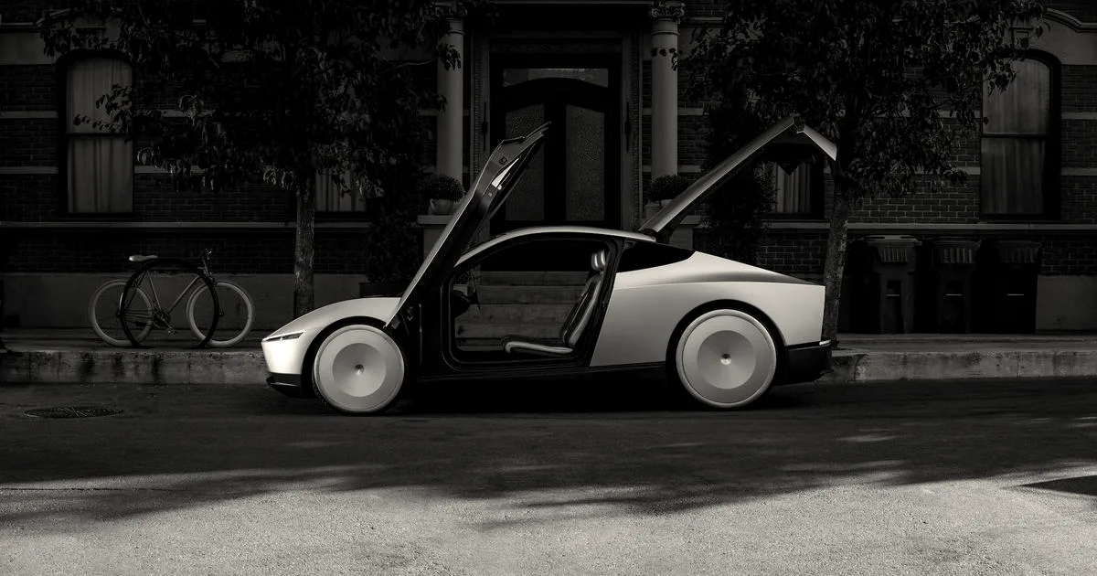 A gold-colored Tesla Cybercab parked on a city street with its butterfly door and rear hatch open.