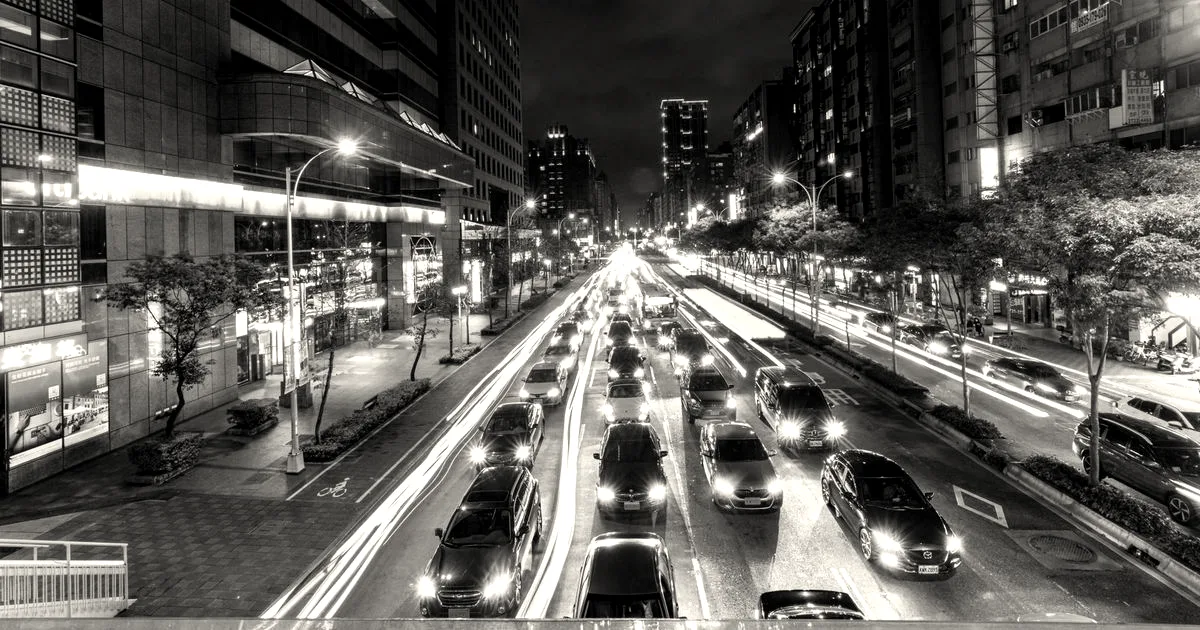 Nighttime traffic lights in a bustling city scene showcasing vibrant urban life.
