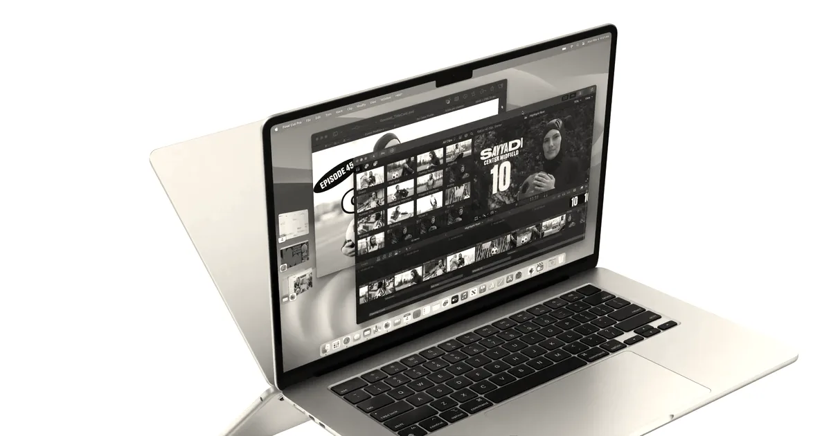 A silver MacBook Air laptop shown open at an angle, displaying video editing software on its screen.