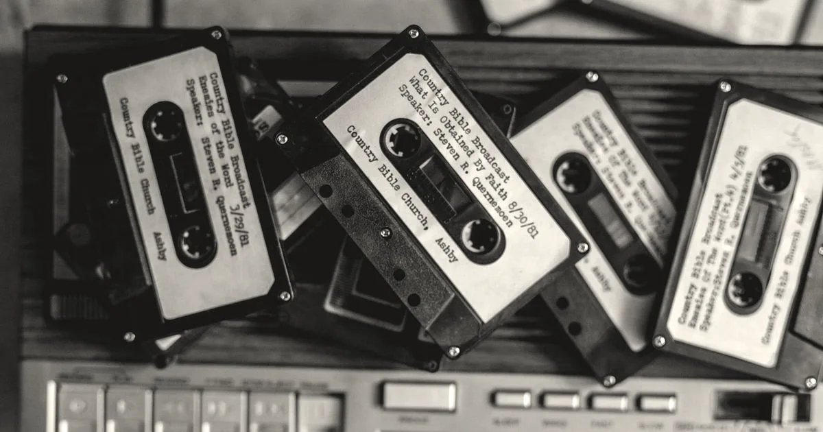 Pile of vintage cassette tapes on a classic audio player, evoking nostalgia and vintage charm.