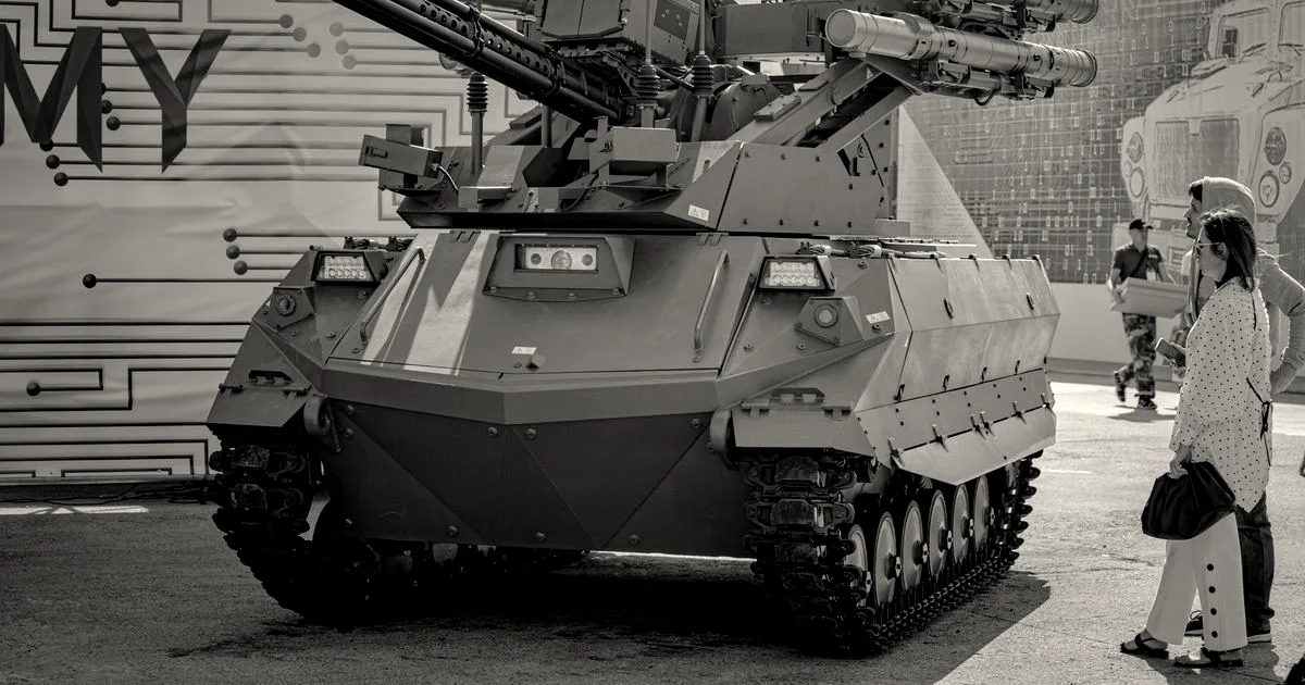 An unmanned tracked robotic combat vehicle equipped with an autocannon and missile launchers on outdoor display.