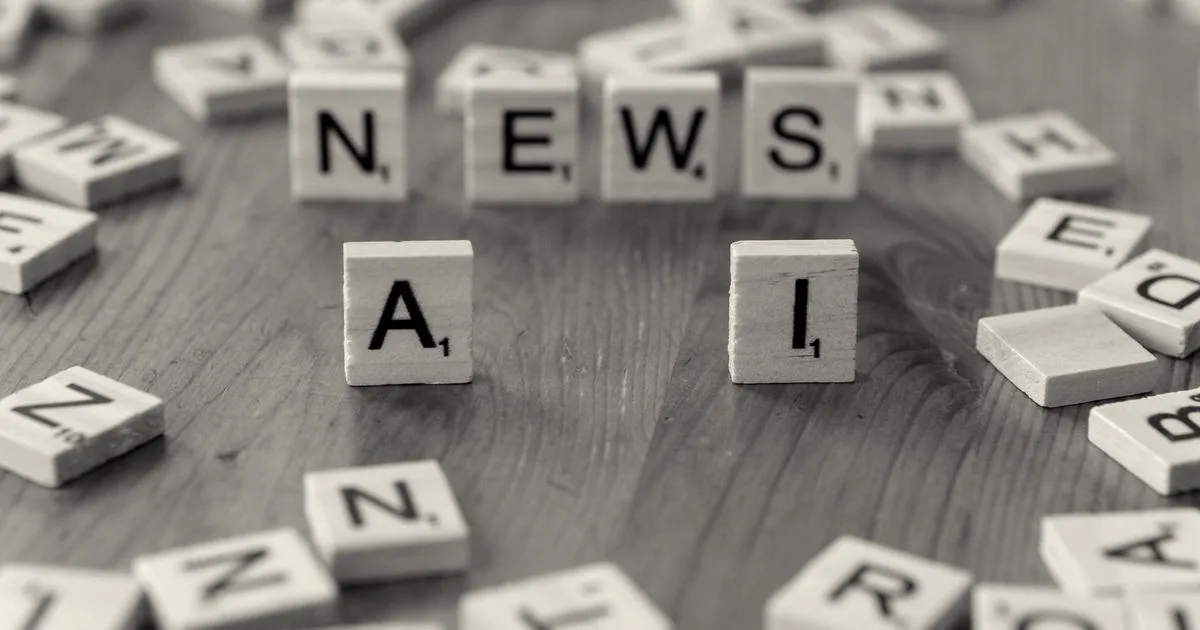 Wooden Scrabble tiles spelling out NEWS and AI on a wooden surface.