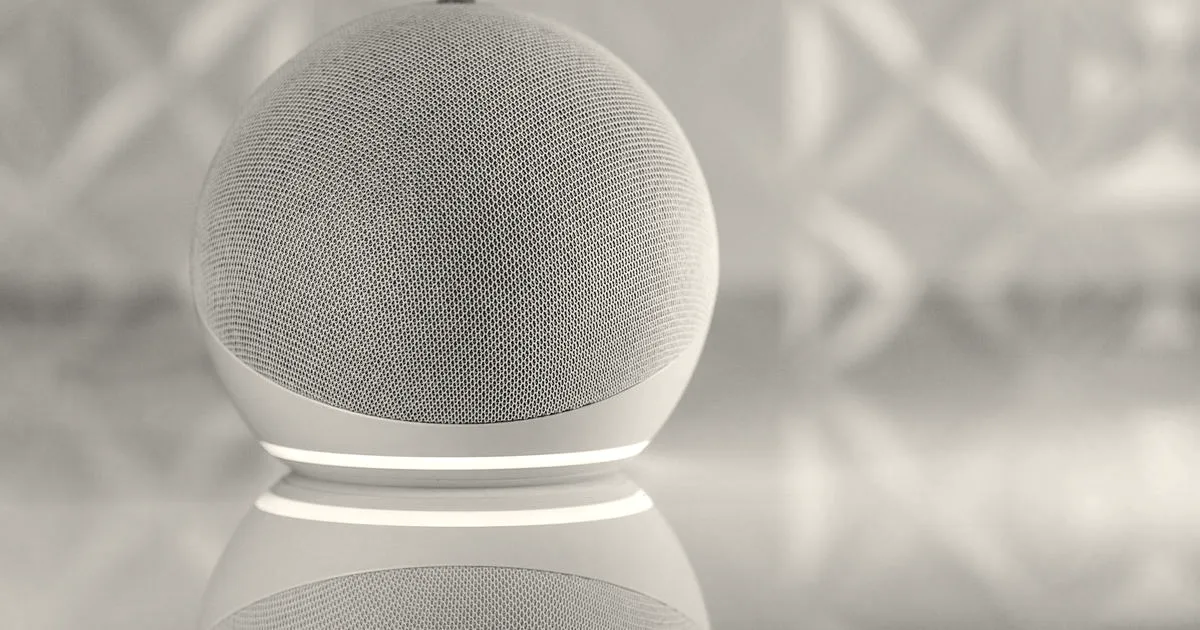 A sleek smart speaker with neon glow on reflective surface, showcasing modern technology.