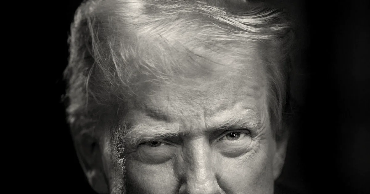 Official portrait of Donald Trump looking forward wearing a dark blue suit and red tie.